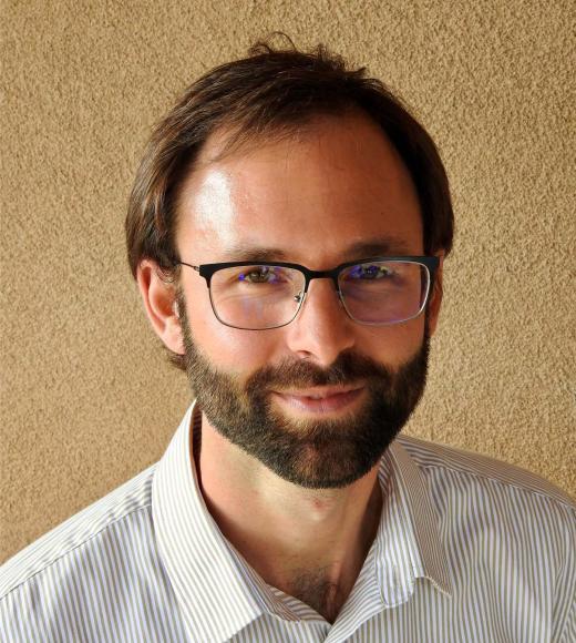 head and shoulders photo of a man in a white shirt