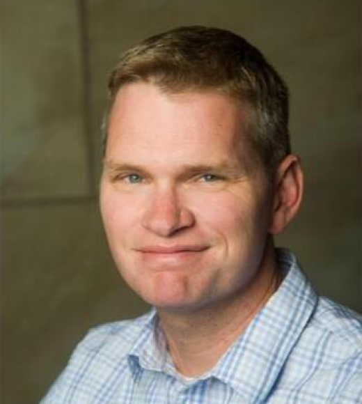 Blonde man in pale blue plaid shirt