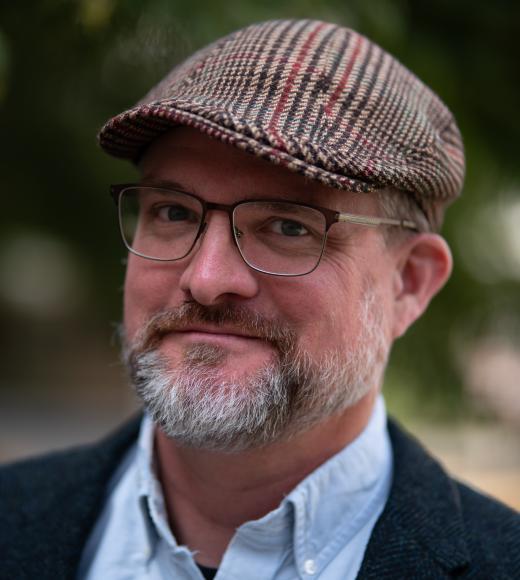 Man with goatee in pageboy hat