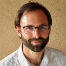 head and shoulders photo of a man in a white shirt