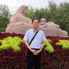 Man standing in front of garden statue
