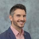 Bearded man in pink shirt and blue blazer