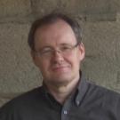 Man posing in front of a whiteboard