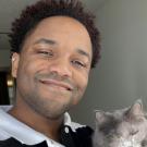 Portrait of a man holding a cat.